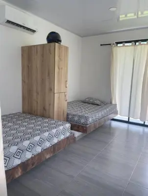 a room with two beds and a cabinet in it at Finca en sopetrán in Sopetran