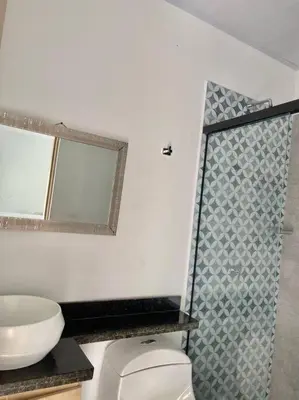 a bathroom with a sink and a toilet and a mirror at Finca en sopetrán in Sopetran