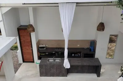 a kitchen in a house with a table and curtains at TerraMonte in Honda