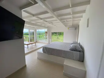 a bedroom with a bed and a tv in a room at TerraMonte in Honda