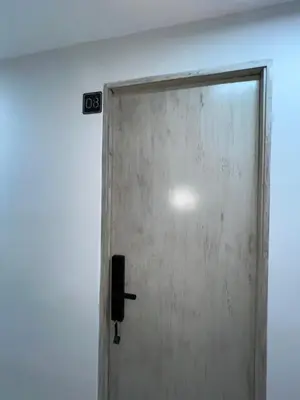 a door in a room with a sign on the wall at Laureles Inn in América