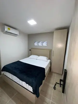a bedroom with a large bed in a room at Laureles Inn in América