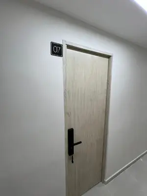 a door in a white wall with a speaker at Laureles Inn in América
