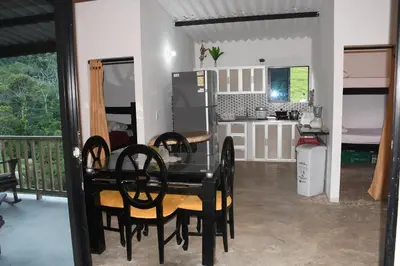 a kitchen and dining room with a table and chairs at Hospedaje Casa Madre los alemanes in Cháquiro