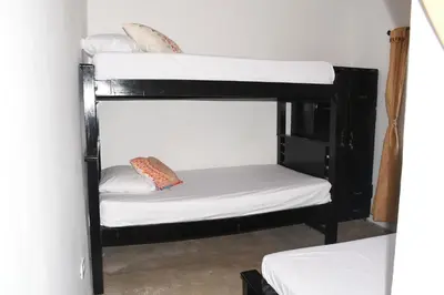 a couple of bunk beds in a room at Hospedaje Casa Madre los alemanes in Cháquiro