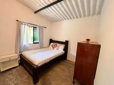 a small bedroom with a bed and a window at Hospedaje Casa Madre los alemanes in Cháquiro