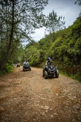 two people riding on atvs on a dirt road at Refugio Natural - Cabañas Ecológicas con Jacuzzi, Guarne in Guarne