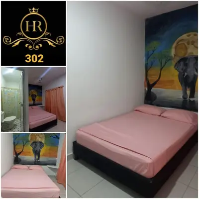 a bedroom with a pink bed and a painting of an elephant at HotelHR in Doradal