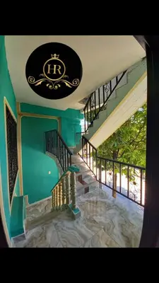 a staircase in a house with a sign on the ceiling at HotelHR in Doradal