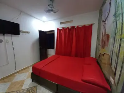 a red bed in a room with a red curtain at HotelHR in Doradal