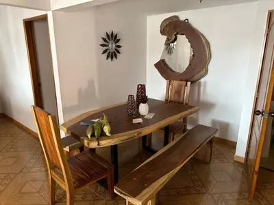 a dining room with a wooden table and a mirror at Apartamento Edicio Torreón en Rionegro in Rionegro