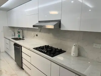 a white kitchen with a stove and white cabinets at Luxury Home Medellin in El Poblado