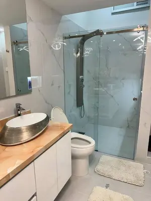 a bathroom with a toilet and a glass shower at Luxury Home Medellin in El Poblado