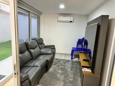 a living room with a couch and a television at Luxury Home Medellin in El Poblado