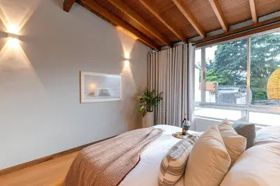 a bedroom with a bed and a large window at Casa Serena Provenza in Medellín