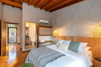 a bedroom with a large white bed in a room at Casa Serena Provenza in Medellín