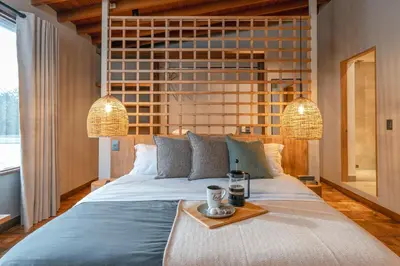 a bedroom with a large bed with a tray on it at Casa Serena Provenza in Medellín