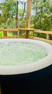 a large hot tub sitting on top of a deck at Boreal Refugio Natural in Sonsón