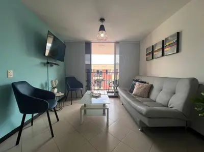 a living room with a couch and a table at Envigado Sereno in Envigado