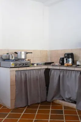 a table with a table cloth on it in a kitchen at Hospedaje RioBosque San Carlos in San Carlos