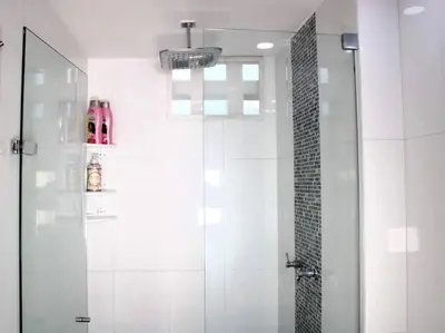a shower with a glass door in a bathroom at Luxury Studio in El Poblado Modern Charm in Envigado