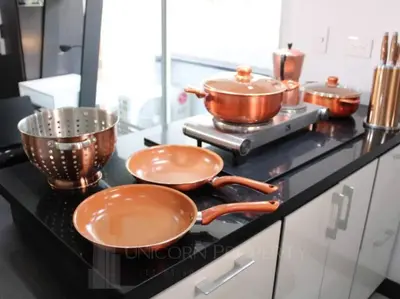 three pots and pans on a counter in a kitchen at Luxury Studio in El Poblado Modern Charm in Envigado