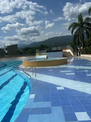 a large swimming pool with blue tiles on it at Hermosa Cabaña Familiar in San Jerónimo