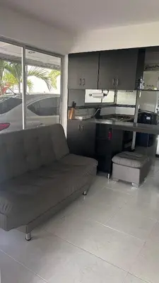 a living room with a couch and a table at Hermosa Cabaña Familiar in San Jerónimo