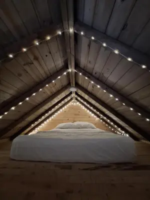 a bed in a room with lights on it at Cabaña Del bosque in Santa Elena