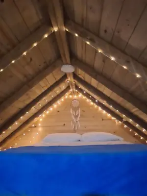 a room with a ceiling with lights on it at Cabaña Del bosque in Santa Elena