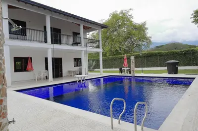 a swimming pool in front of a house at Acogedora Casa-Finca en Sopetran, Antioquia in Corral Falso
