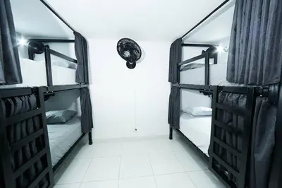 a room with two bunk beds in a dorm at Acogedora casa cerca al estadio in Robledo