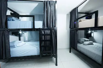 a room with three bunk beds in a room at Acogedora casa cerca al estadio in Robledo