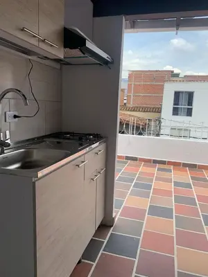 a kitchen with a sink and a large window at Hostal CasaBlanca, Laureles Estadio in Medellín