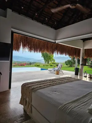 a bedroom with a bed and a view of a pool at Villa en La Pintada con Piscina in La Pintada