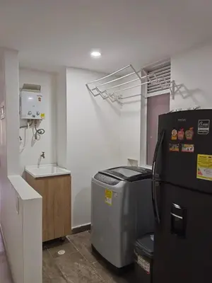 a kitchen with a refrigerator and a sink at For your comfort and confidence in Sabaneta