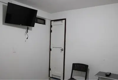 a flat screen tv hanging on a wall next to a door at Donde María Yarce Casa Turística in Jardin