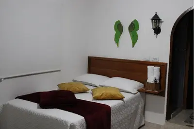 a bedroom with two beds and a lamp at Donde María Yarce Casa Turística in Jardin