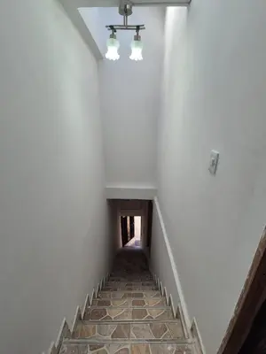a staircase in an empty room with a ceiling at GIGANTE y ELEGANTE APARTAMENTO UNIFAMILIAR in Belén