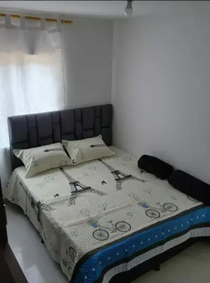 a bedroom with a bed with a quilt on it at GIGANTE y ELEGANTE APARTAMENTO UNIFAMILIAR in Belén