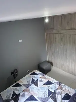 a bedroom with a bed with a quilt on it at GIGANTE y ELEGANTE APARTAMENTO UNIFAMILIAR in Belén