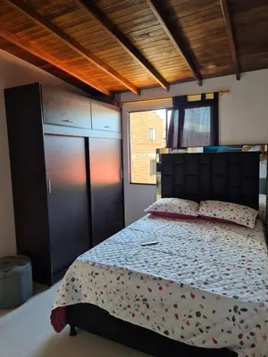 a bedroom with a large bed with flowers on it at GIGANTE y ELEGANTE APARTAMENTO UNIFAMILIAR in Belén