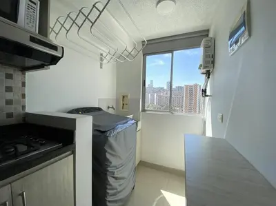 a small kitchen with a counter and a window at Central Family Home with Air Conditioning in Sabaneta
