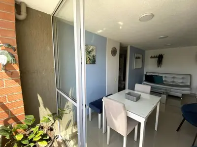 a living room with a white table and a couch at Central Family Home with Air Conditioning in Sabaneta