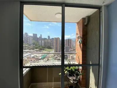 a view of a city skyline from a window at Central Family Home with Air Conditioning in Sabaneta