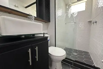 a bathroom with a toilet and a sink and a shower at Charm of Las Palmas in El Salvador