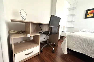 a bedroom with a desk and a bed at Charm of Las Palmas in El Salvador