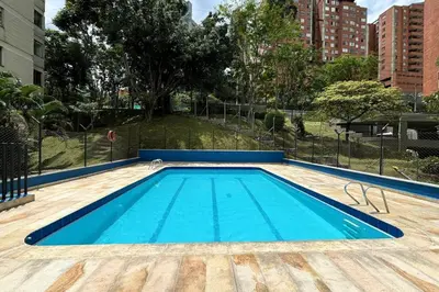 a swimming pool with blue water in a city at Charm of Las Palmas in El Salvador
