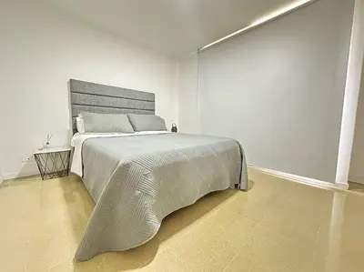 a white bedroom with a large bed in a room at Cozy Studio Apartment in Poblado with Jacuzzi in Medellín