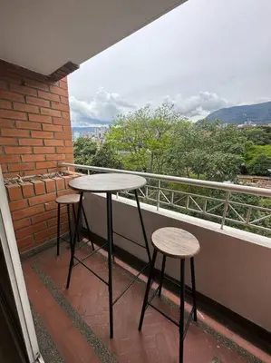 a balcony with two tables and two stools at Cozy Studio Apartment in Poblado with Jacuzzi in Medellín